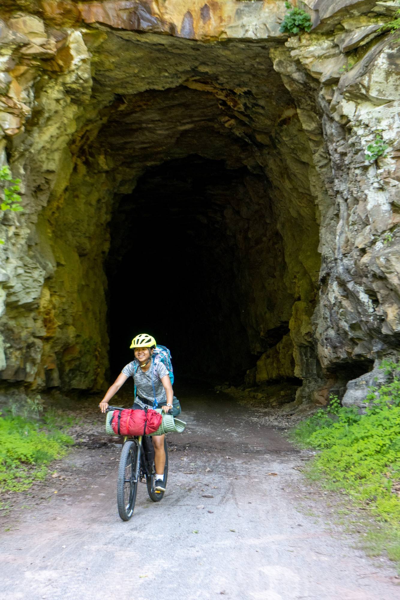 Maya Snyder bikes through a tunnel on the Greenbrier Rail Trail in Southern West Virginia.