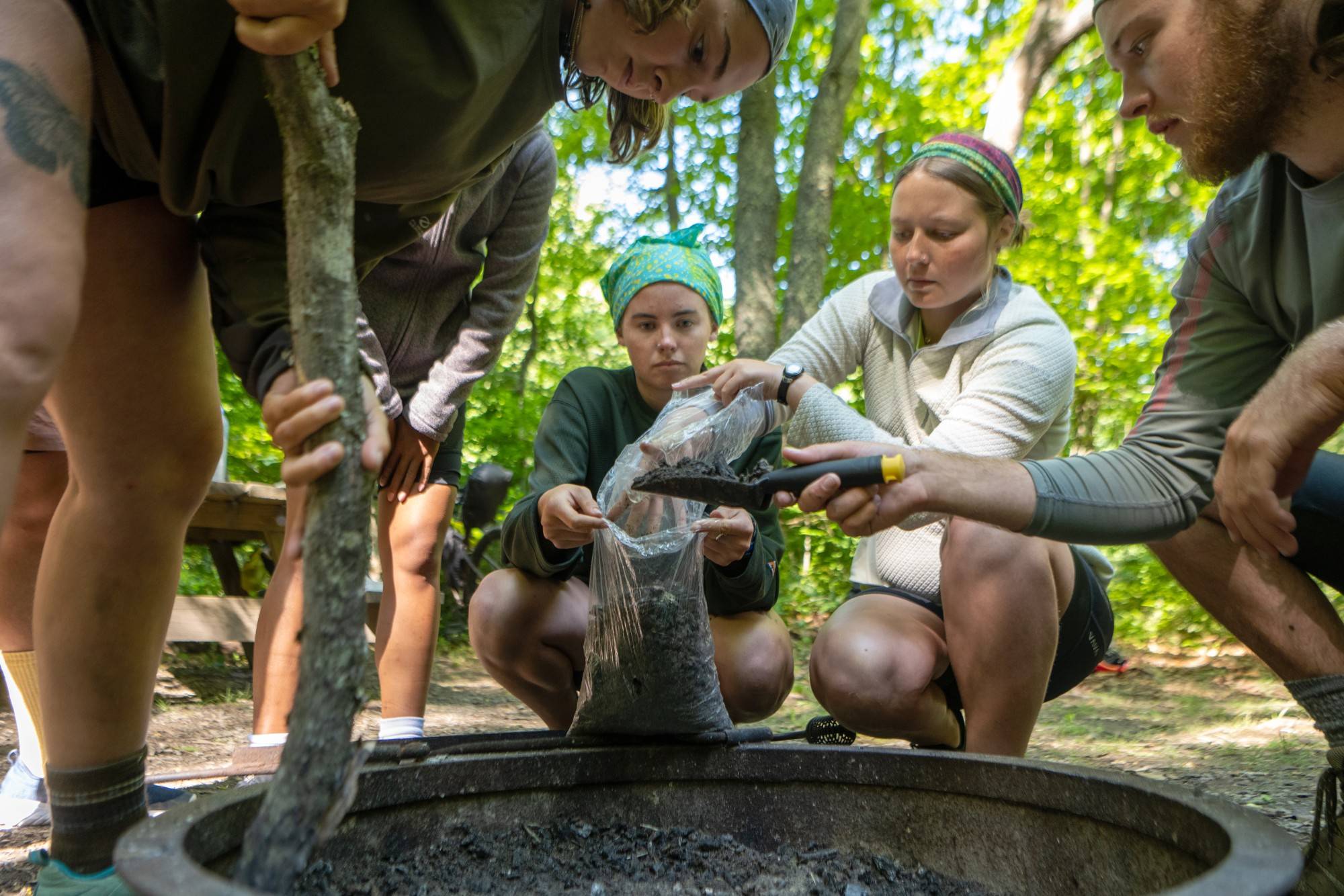 Students learn best practices for how to clean up a campfire.
