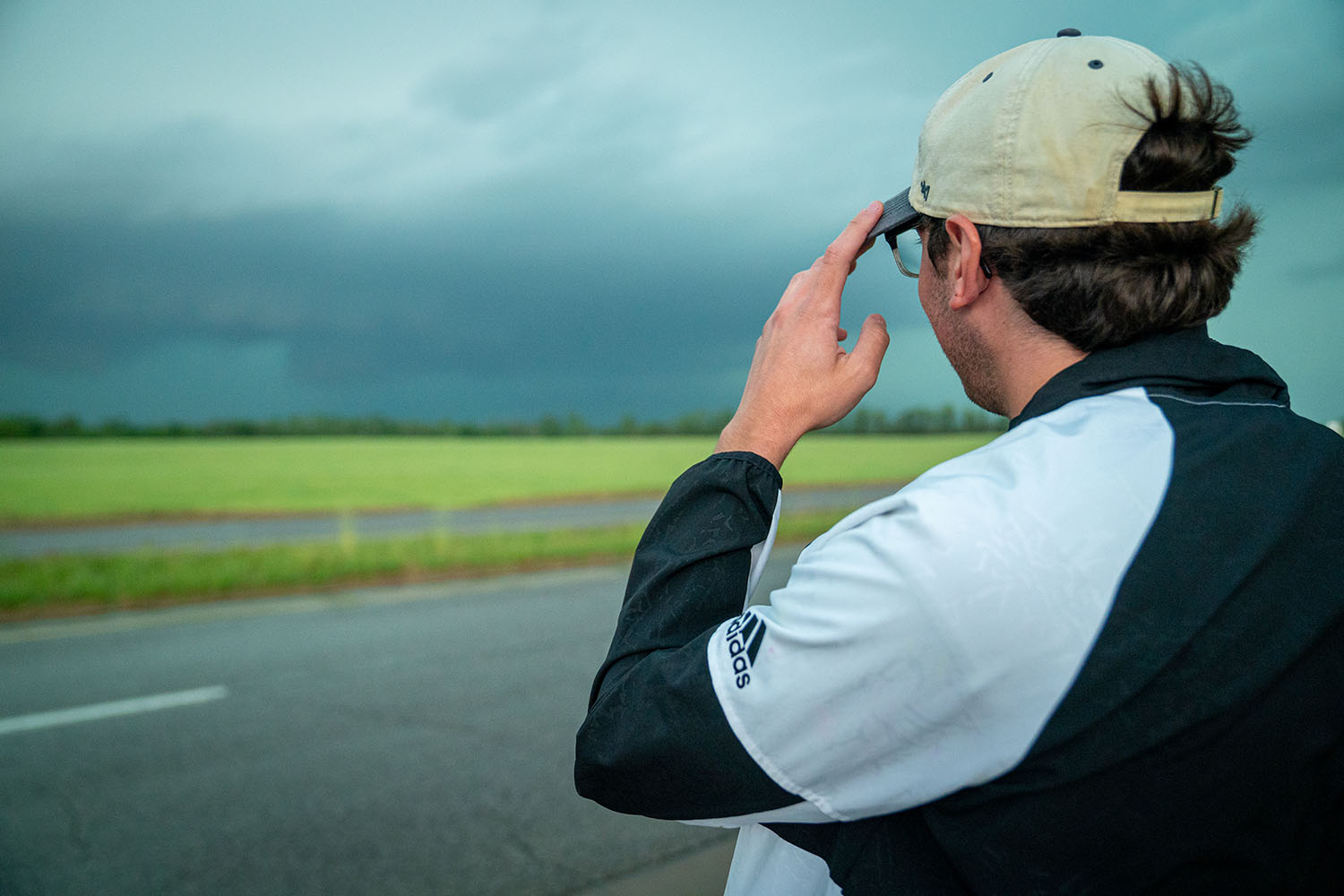 OHIO student Adam Eckman looks towards a storm cell.