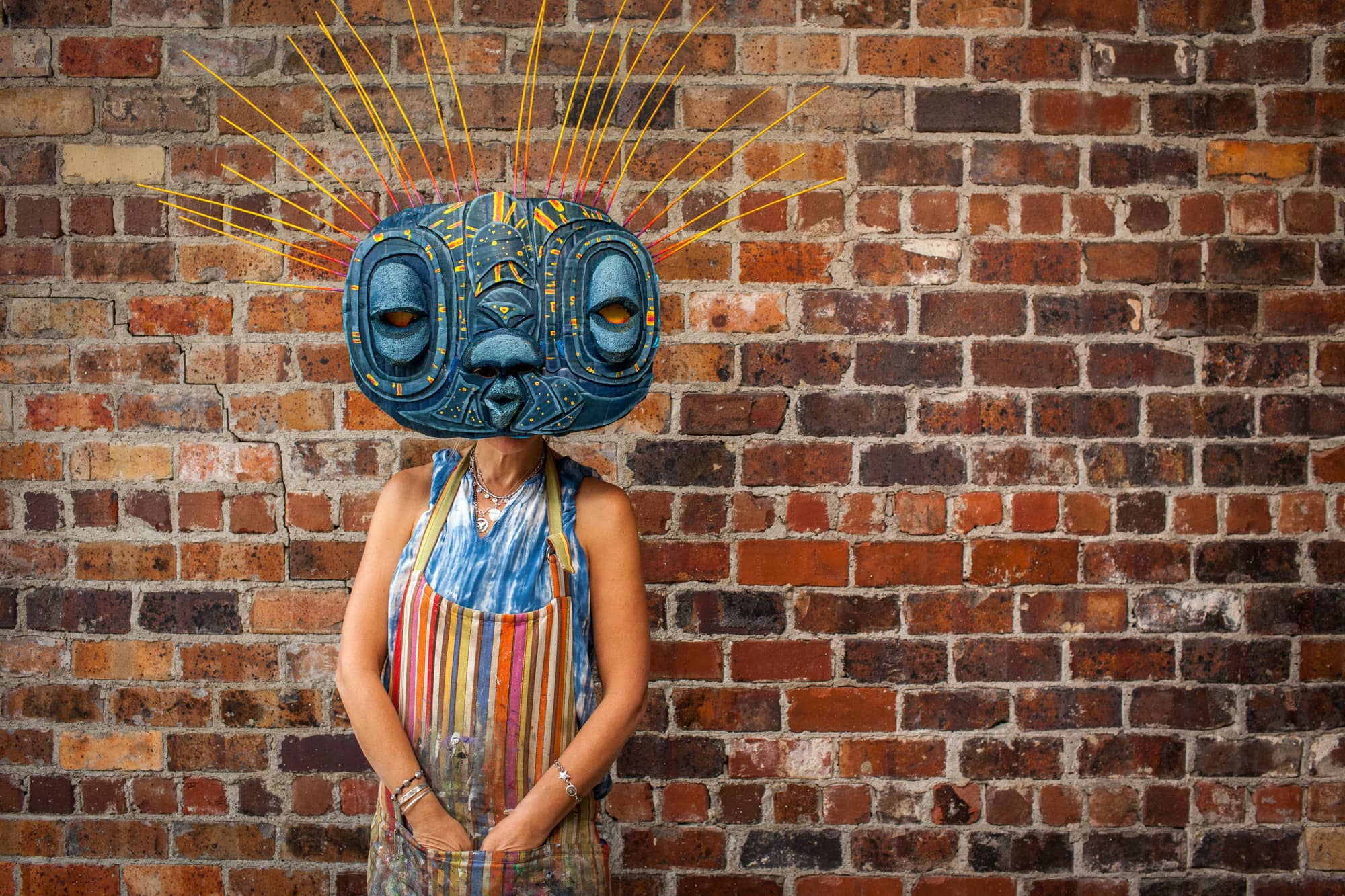 Wendy Minor Viny, a regional artist who works with Passion Works Studio in Athens, models a DIY Halloween mask for the annual Honey for the Heart parade. The mask, created by Viny, can be made with cardboard, a pool noodle, a bike inner-tube, and some paint.