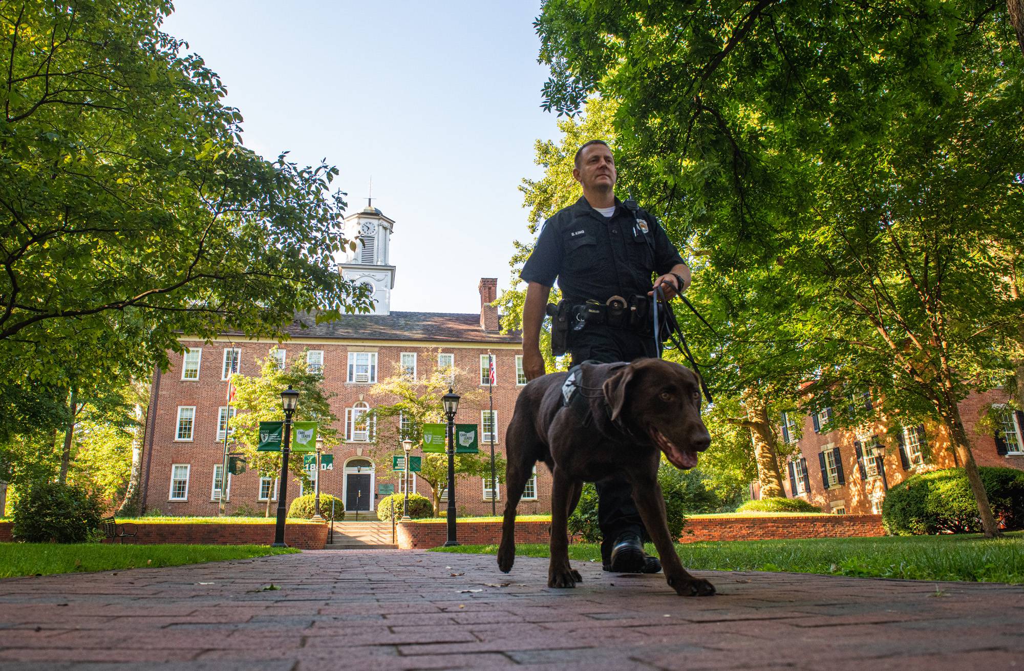 Bach and his handler, Officer Brandon King, walk across College Green. While King has served over 20 years at the University, Bach is his first K9 partner.