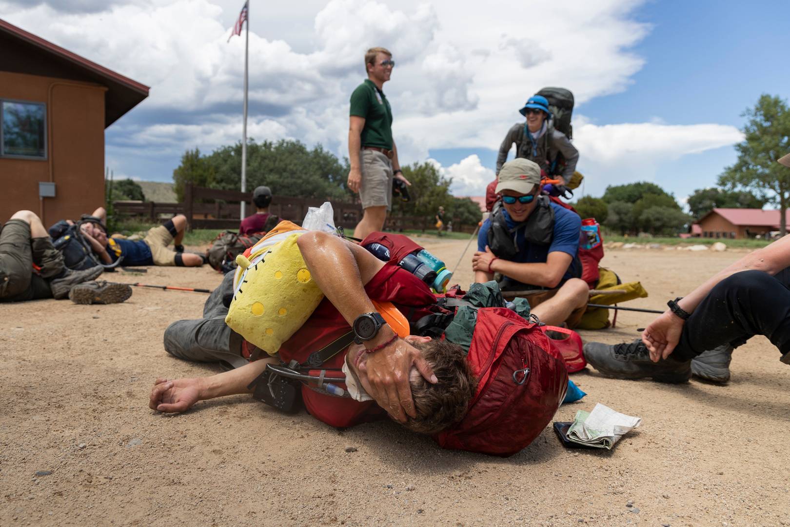 A Rayado member rests as he realizes he finished his 21-day trek at Phimont Scout Ranch in Cimarron, N.M., on July 9, 2022.