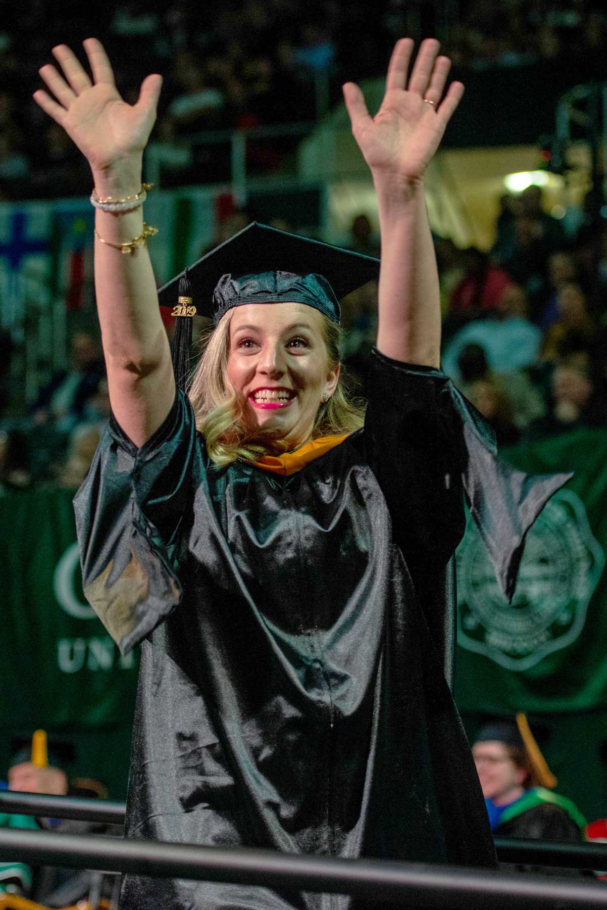 Student waves to family during 2019 Fall Commencement