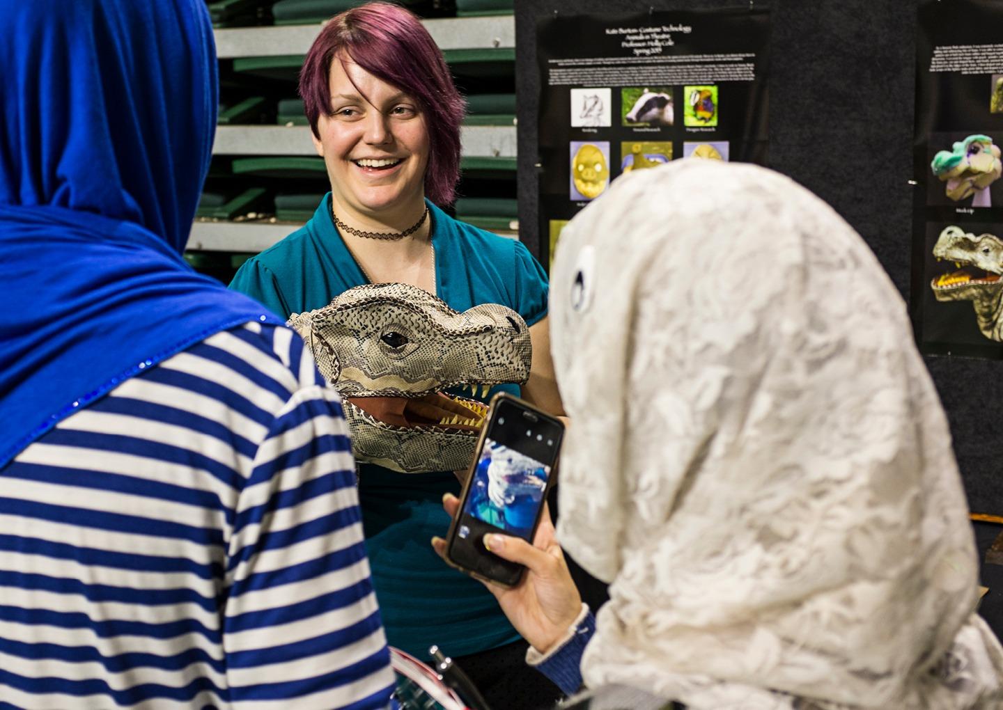 First-year MFA theater student Kate Burton shares her process for building a dinosaur puppet during the 2015 Student Expo. Photo by Rob Hardin