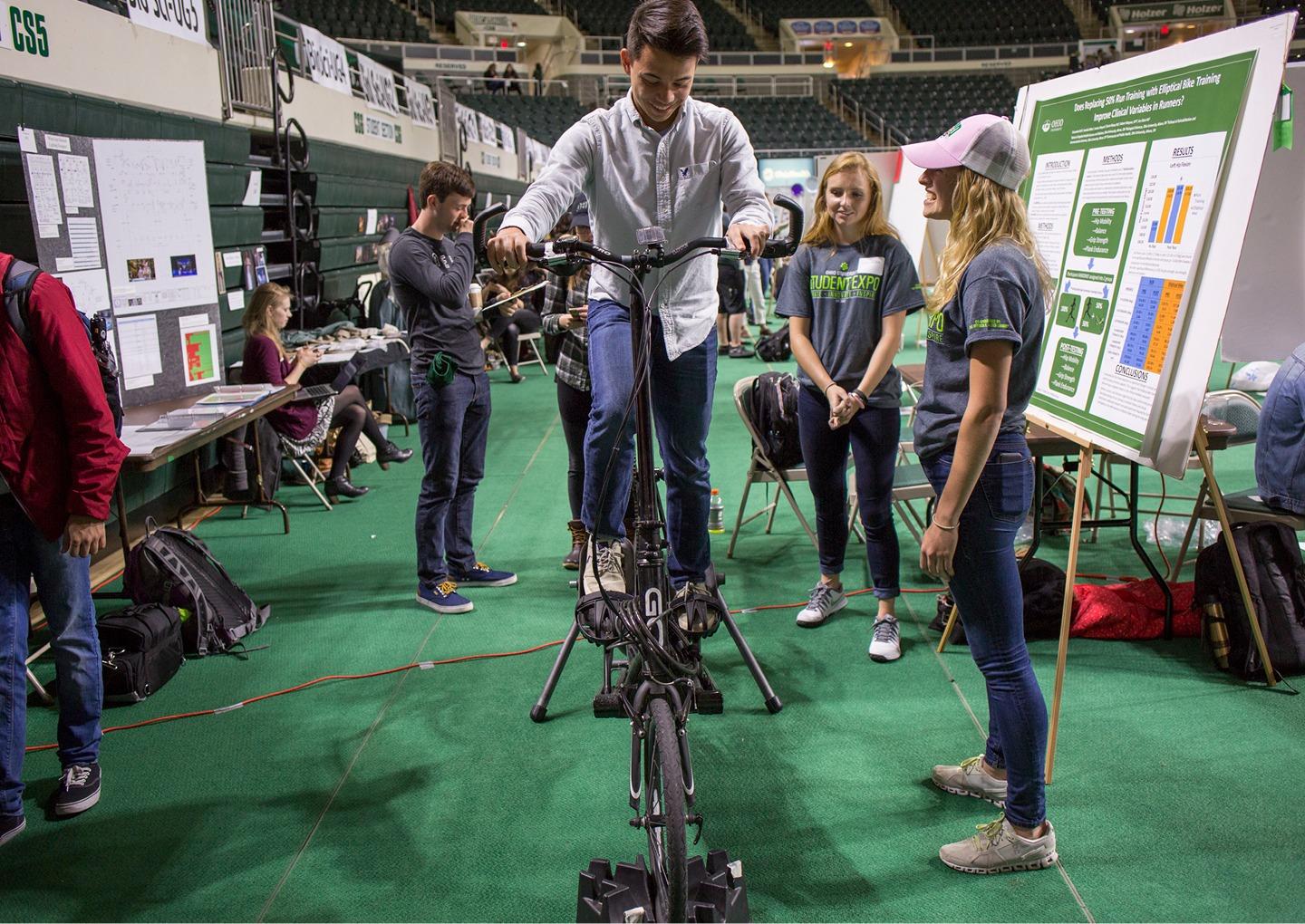 Caedon Ly, a junior at Logan High School, tries out an elliptical bike at the 2017 Student Expo. Photo by Emily Matthews, BSVC '18