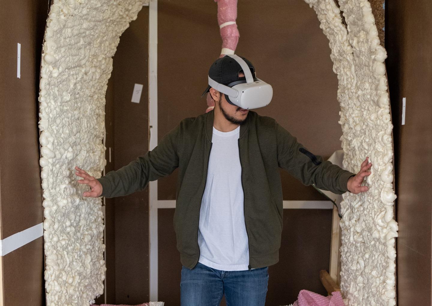 Yugo Naito, MFE ’21, experiences a mixed reality display at the 2022 Student Expo. Undergraduate and graduate students from the Scripps College of Communication created a sensory experience that imitated walking inside a whale. Photo by Ben Wirtz Siegel, BSVC '02