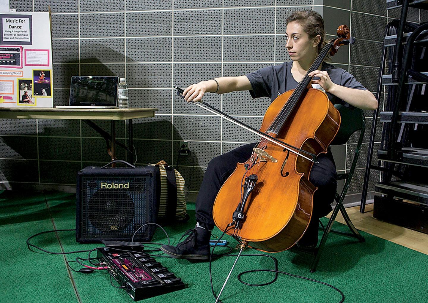 Lily Gelfand, BFA ’18 (HTC), demonstrates how to use a looper pedal system at the 2016 Student Expo. She uses the same looping pedal in her work today. Photo by Emily Matthews, BSVC ’18