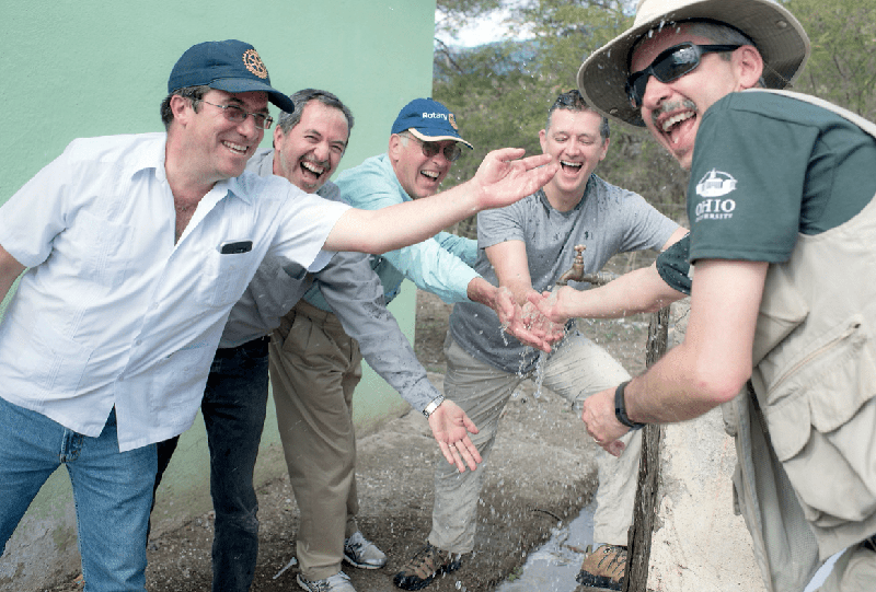 Mario Grijalva on an educational trip to South America - splashing in water with colleagues