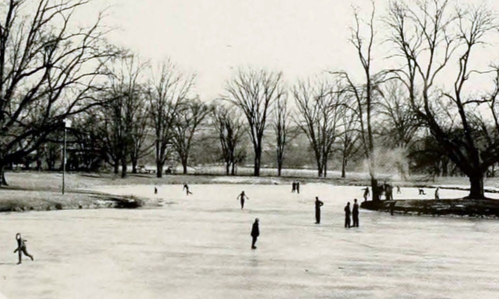 people ice skating on a frozen pond