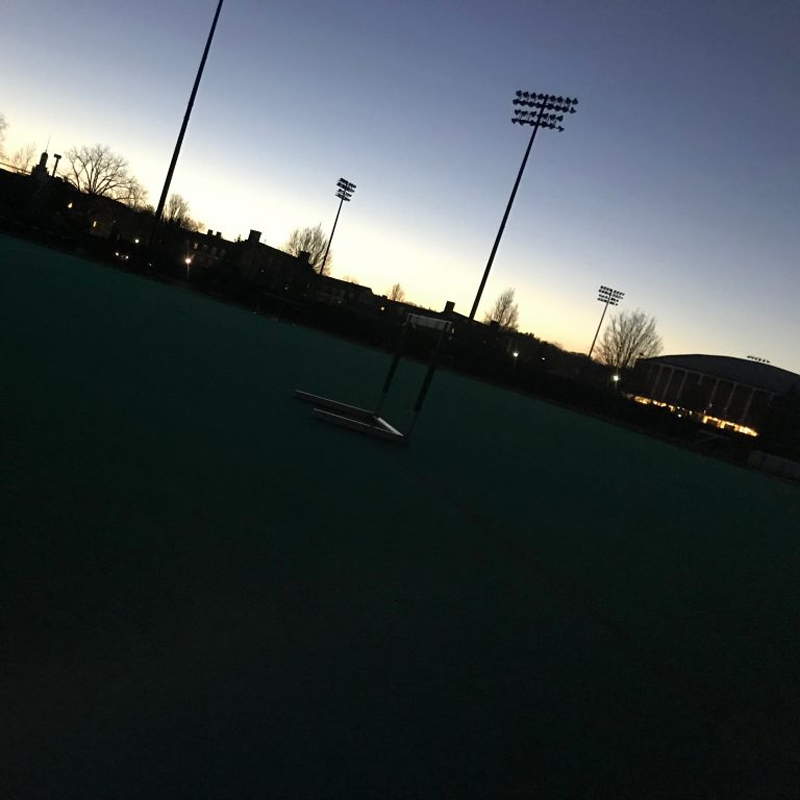 slanted view of track field with hurdles at dawn