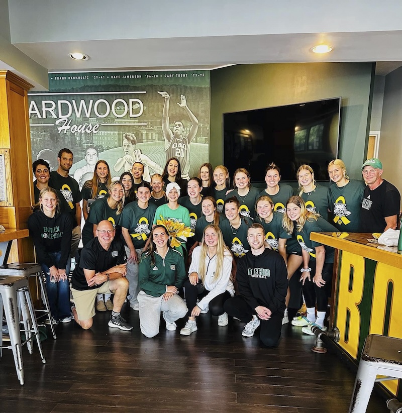 A large group of people, most wearing Bobcat gear, pose together