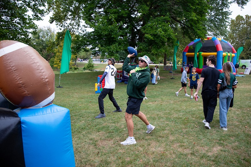 OHIO fans throw footballs and walk through a tailgate area before the game