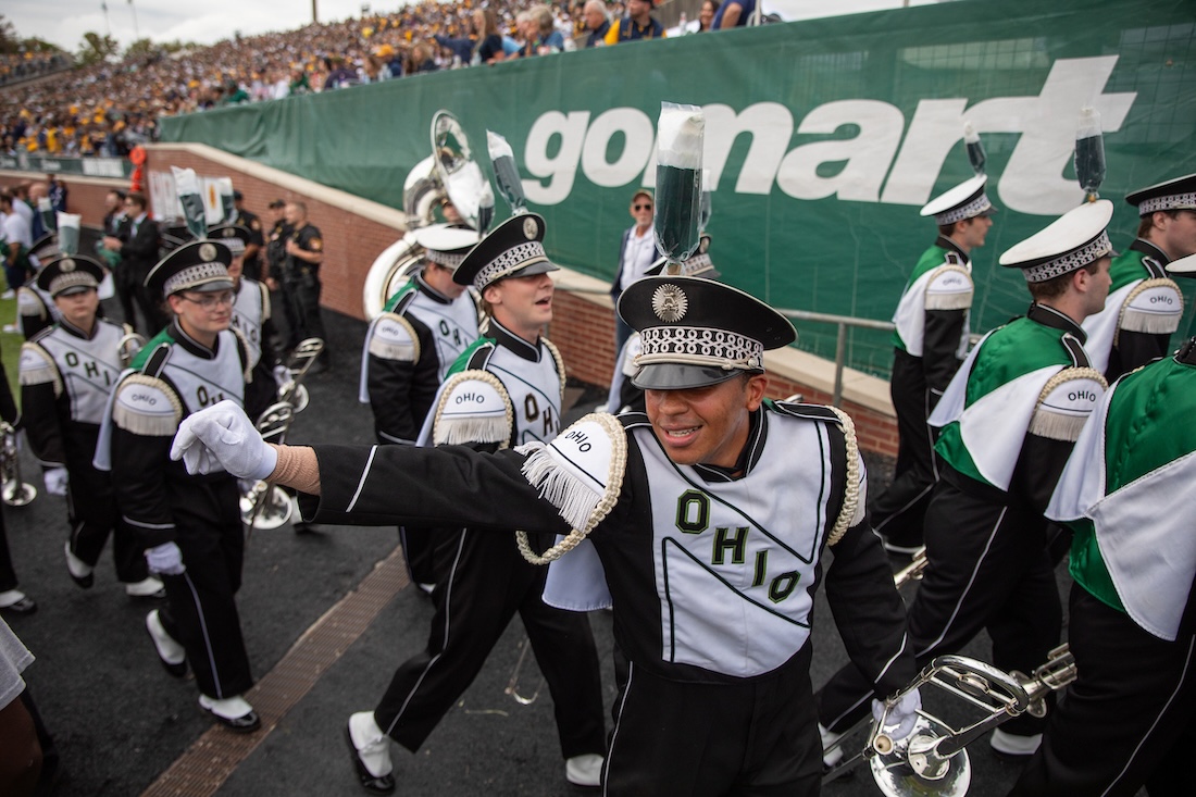 Marching 110 members enter Peden Stadium