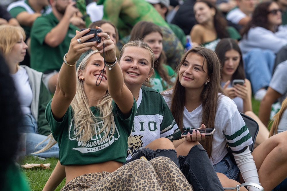 OHIO Fans take a photo of themselves and the crowd while sitting on Victory Hill in Peden Stadium