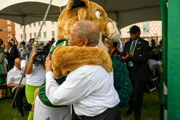 President McDavis hugs Rufus at the dedication ceremony