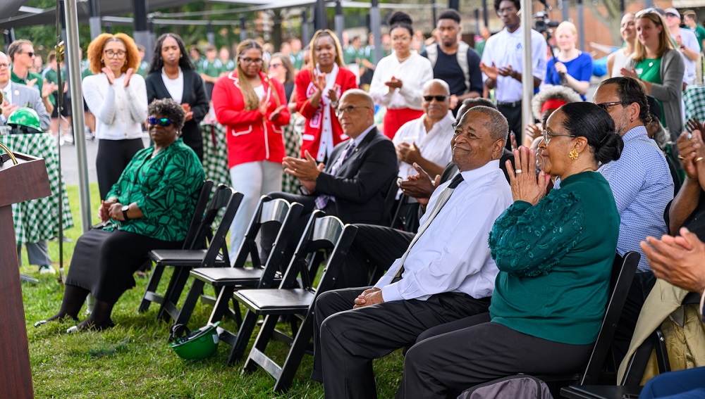 The audience applauds for President McDavis and Deborah McDavis at the dedication ceremony