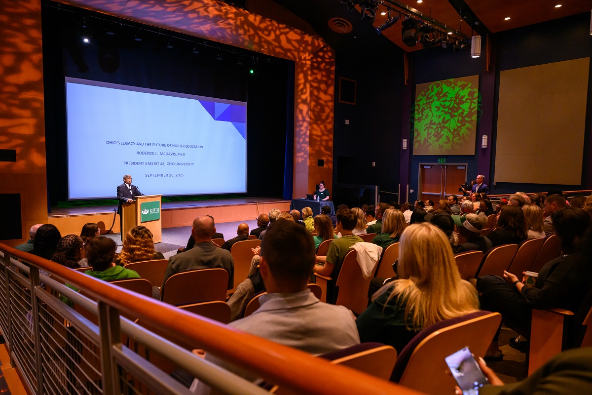 President McDavis presents the lecture to a large crowd in the Baker Theater