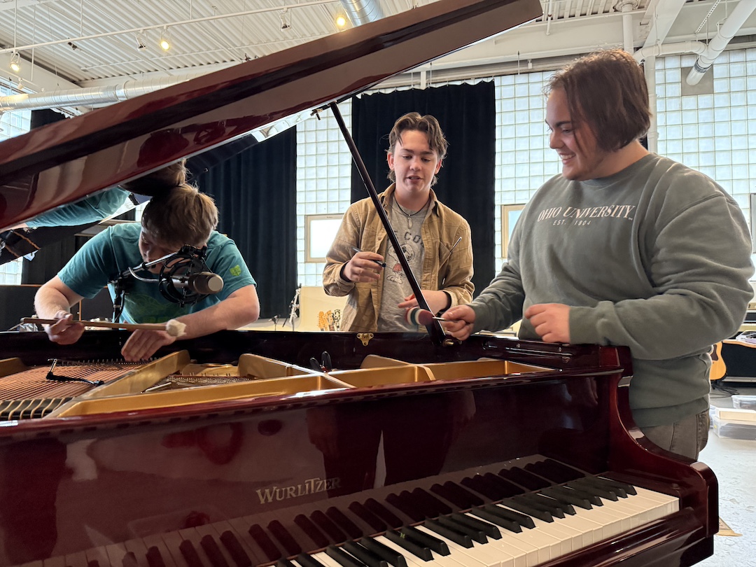 Students work around piano