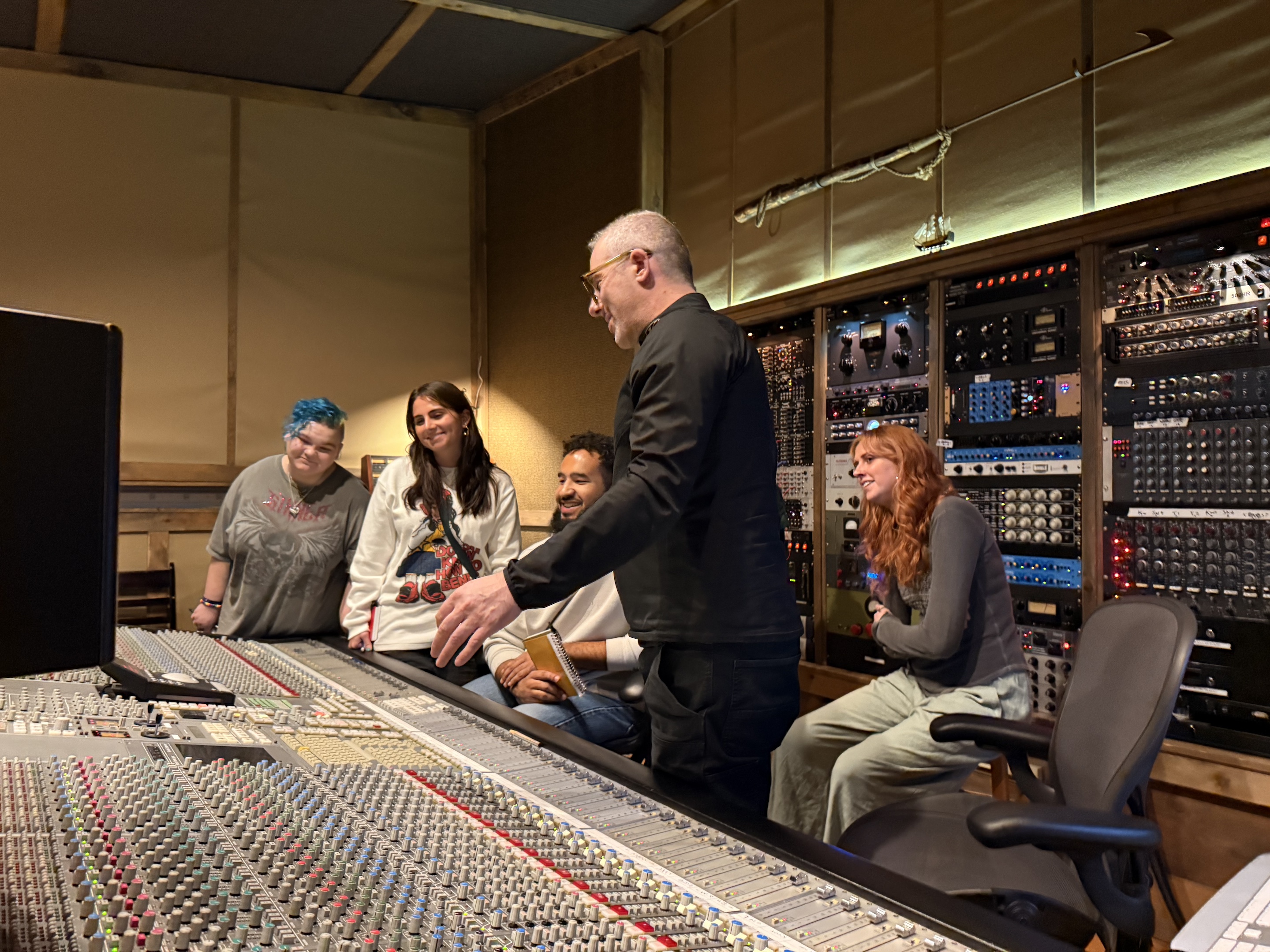 Students observe Joel Hamilton work in his studio