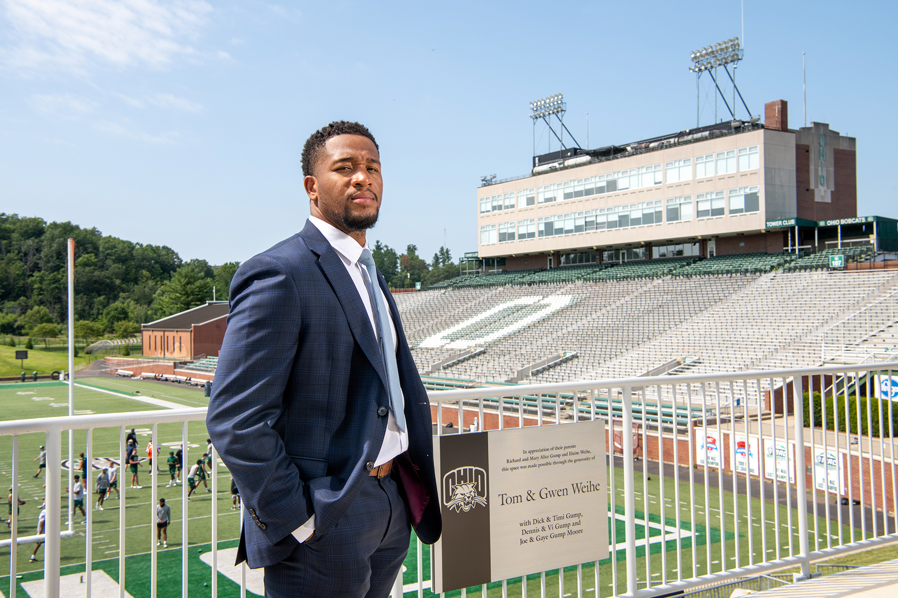 An OHIO Sports Administration student stands on the terrace in front of Peden Stadium.