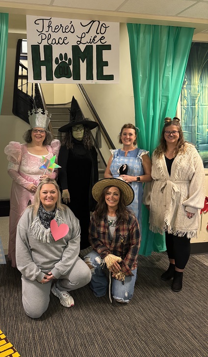 OHIO employees dressed up as characters from the Wizard of Oz pose for a photo in the Business Service Center, which has a Wizard of Oz theme for the Paint the Town Green contest