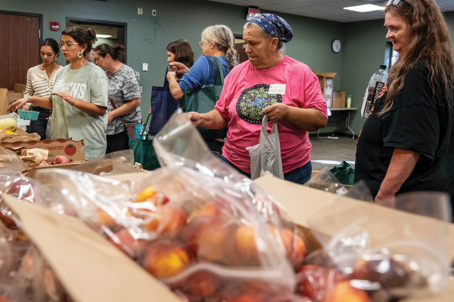 a small group looks at and selects from produce items at a food pantry