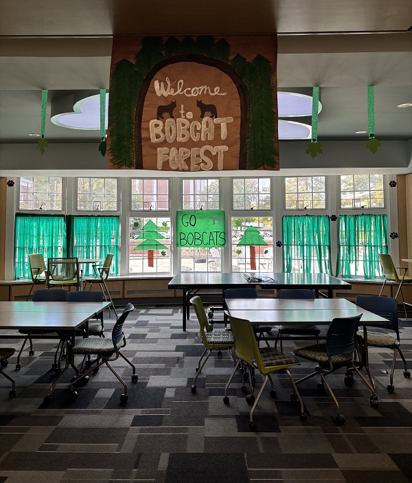 The James Hall lobby is decorated with green streamers and signs that say Welcome to Bobcat Forest and Go Bobcats