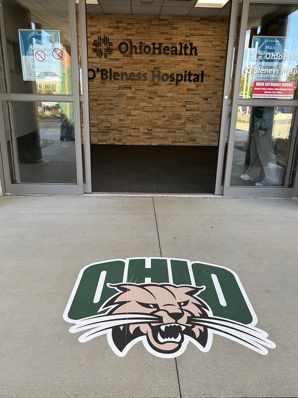 An OHIO Logo is on the sidewalk outside of OhioHealth O'Bleness Hospital