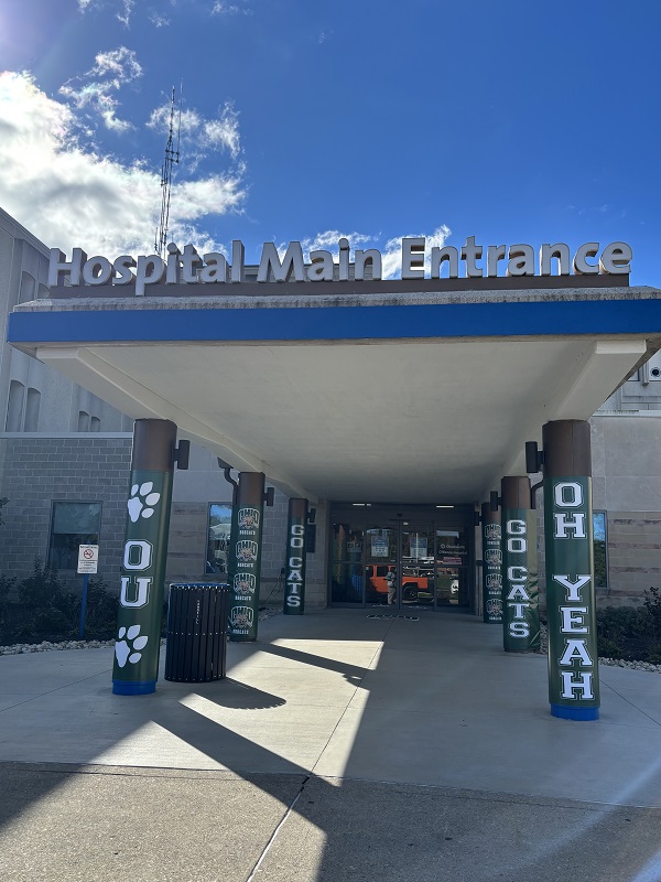 The outside of the Hospital Main Entrance is decorated with signs that say OU, Go Cats and Oh Yeah