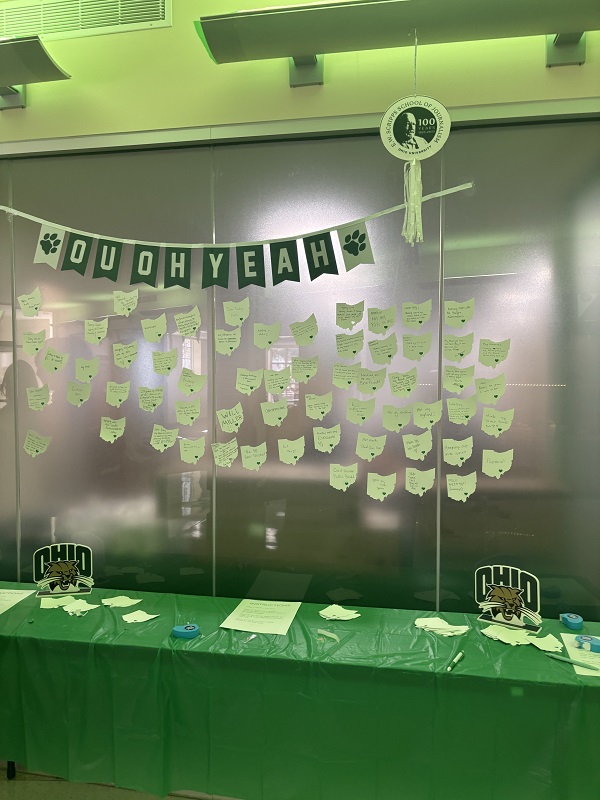 A room is decorated with a banner that reads OU OH YEAH, and there are green OHIO shapes on a wall