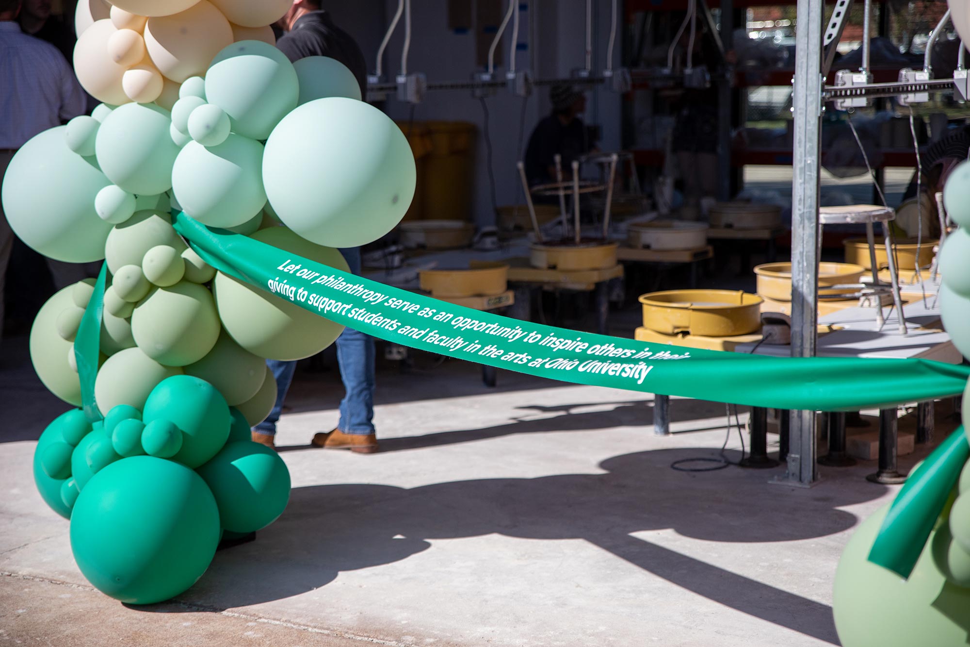 a green ribbon flanked by balloons bears the phrase: “Let our philanthropy serve as an opportunity to inspire others in their giving to support students and faculty in the arts at Ohio University”