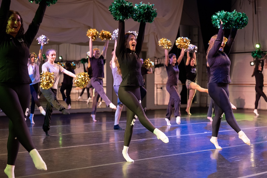 Students daning with pom-poms