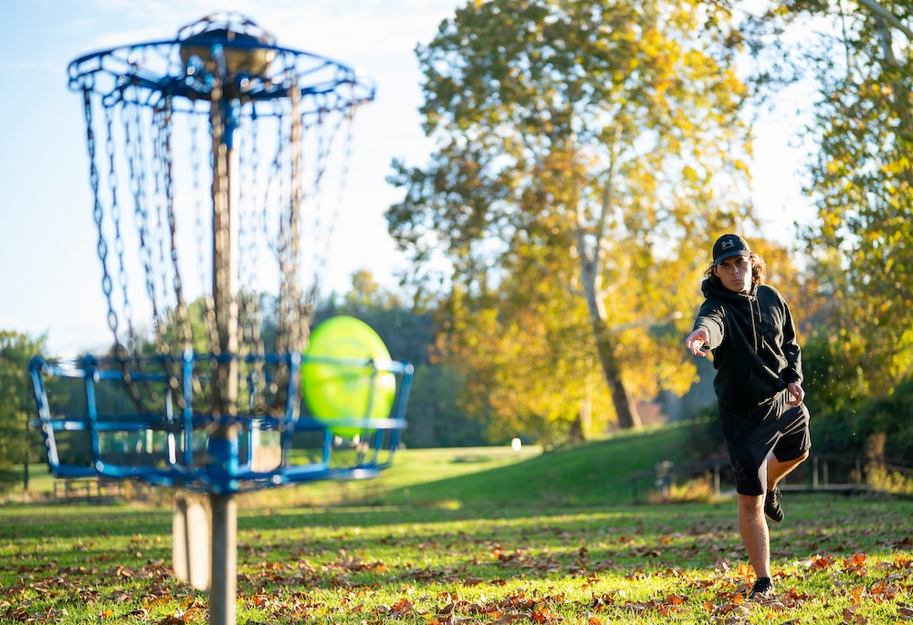 A disc golfer throws a disc