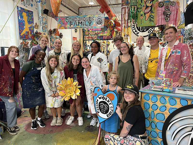 Delaney Lucas at Passion Works Studio with members of OHIO Field Hockey, OHIO Basketball and Athens High School volunteers in the studio.