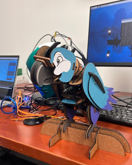 A robot parrot on a desk.