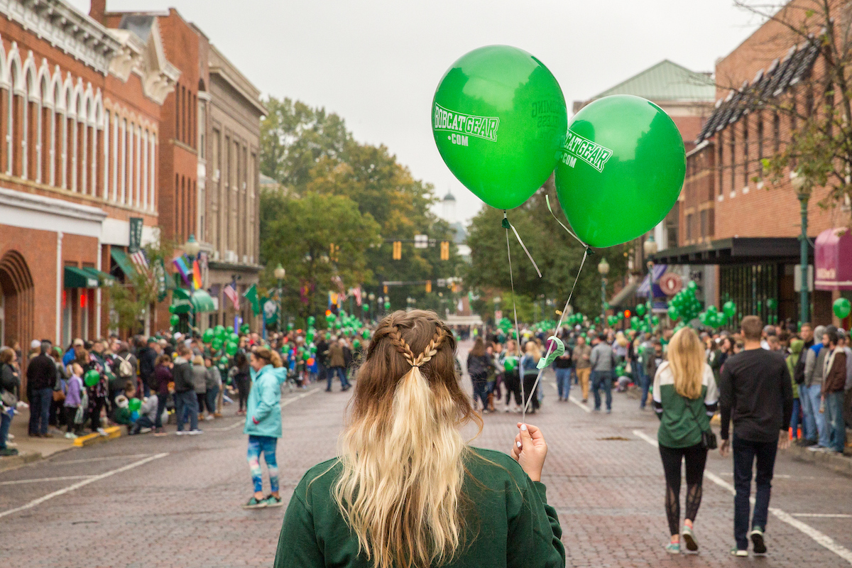 An OHIO student holds balloons on Court Street