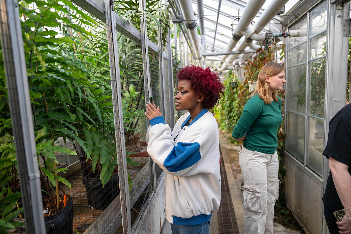Students view a greenhouse at OHIO. 