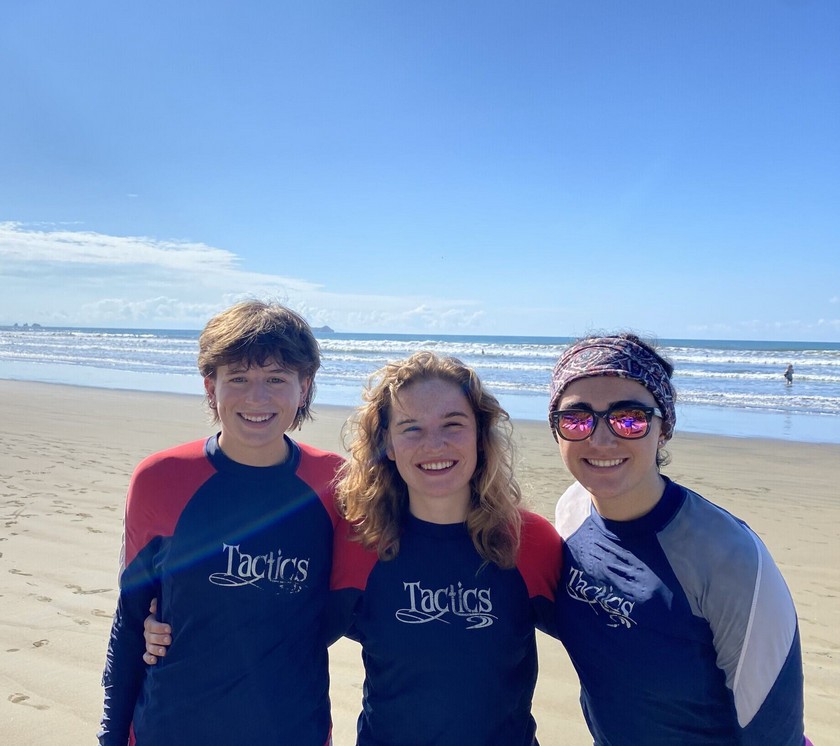 People smiling on a beach.
