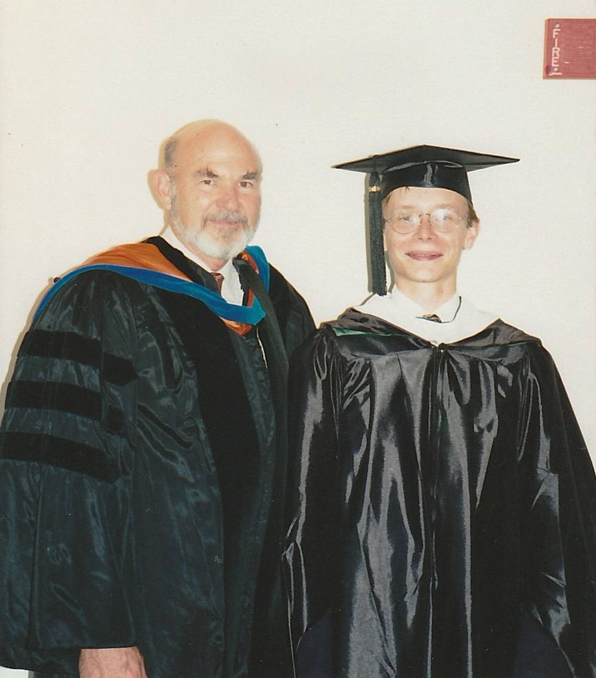 Butorin in his cap and gown alongside Dr. Don Flournoy during his graduation. 
