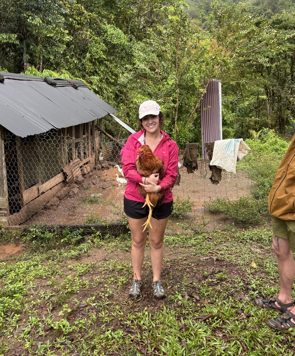 A student holding a chicken.