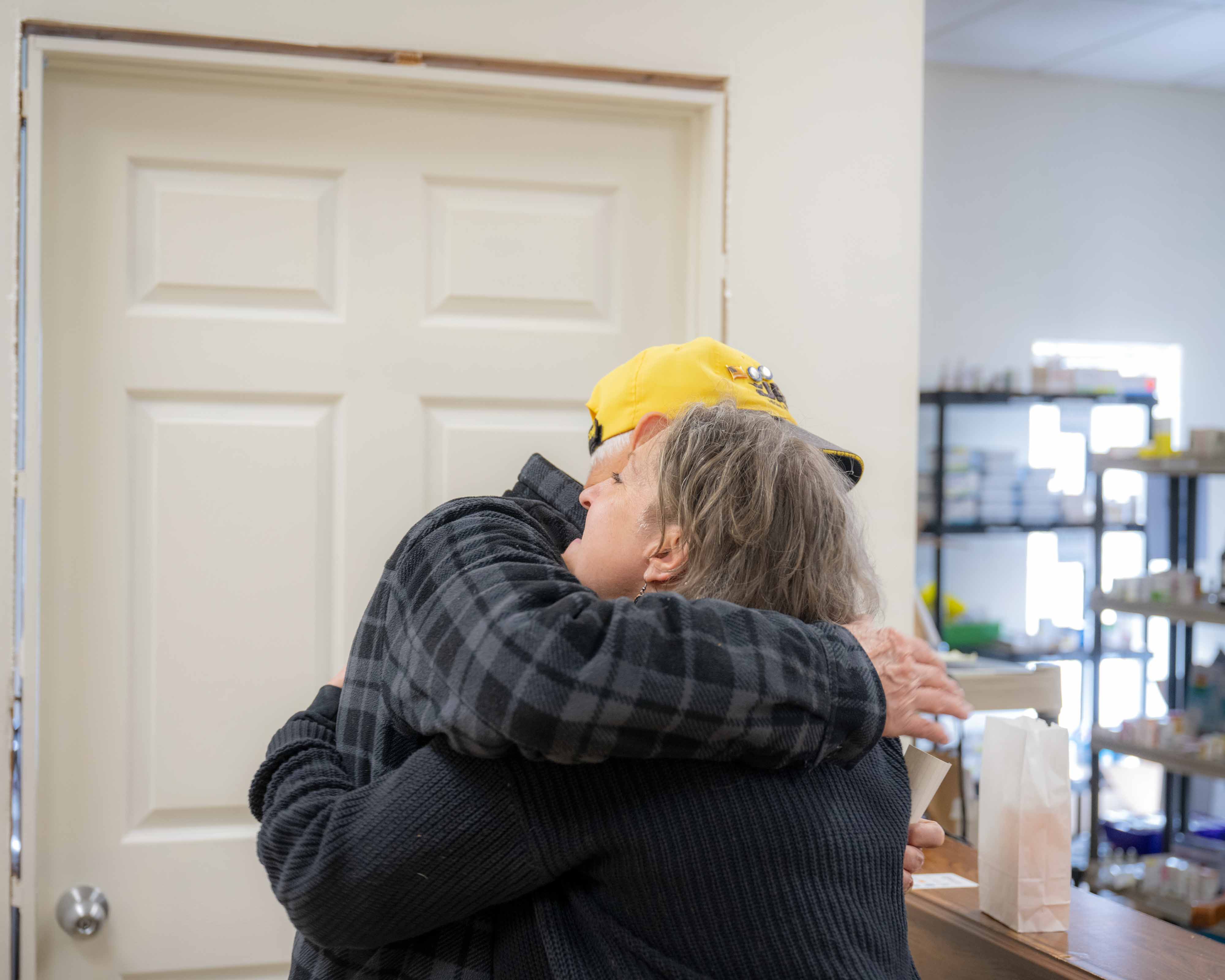 Sarah Adkins hugs a client