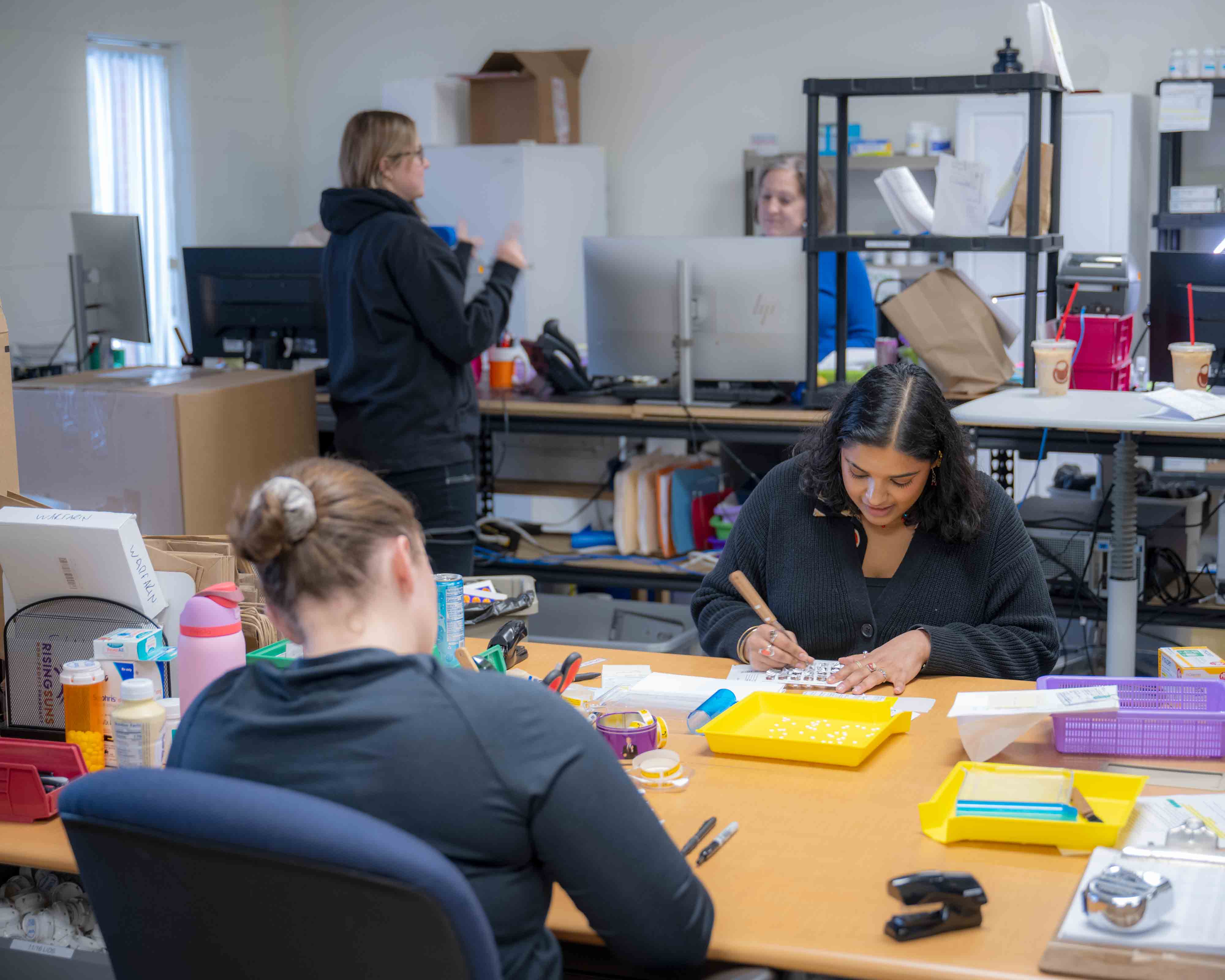 Medical students sort and organize pharmaceuticals
