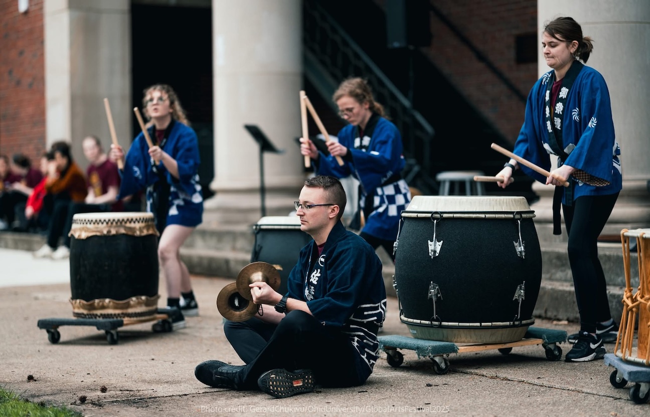 A group of percussionists playing large taiko drums. 