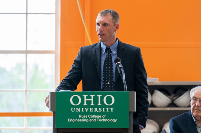 Wm. Bryce Burgett speaks at the podium as part of the ribbon cutting ceremony.