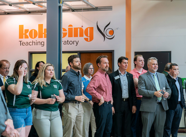A large growd of students, faculty and staff listens to a presentation in the Kokosing Teaching Laboratory