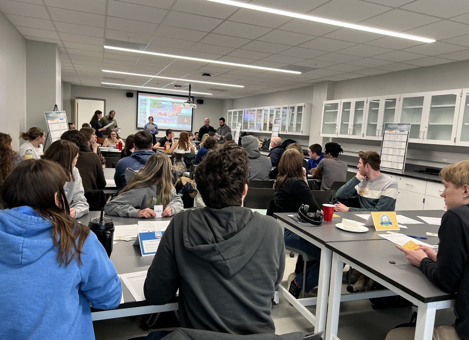 Students sitting down at desks, learning in a classroom setting.