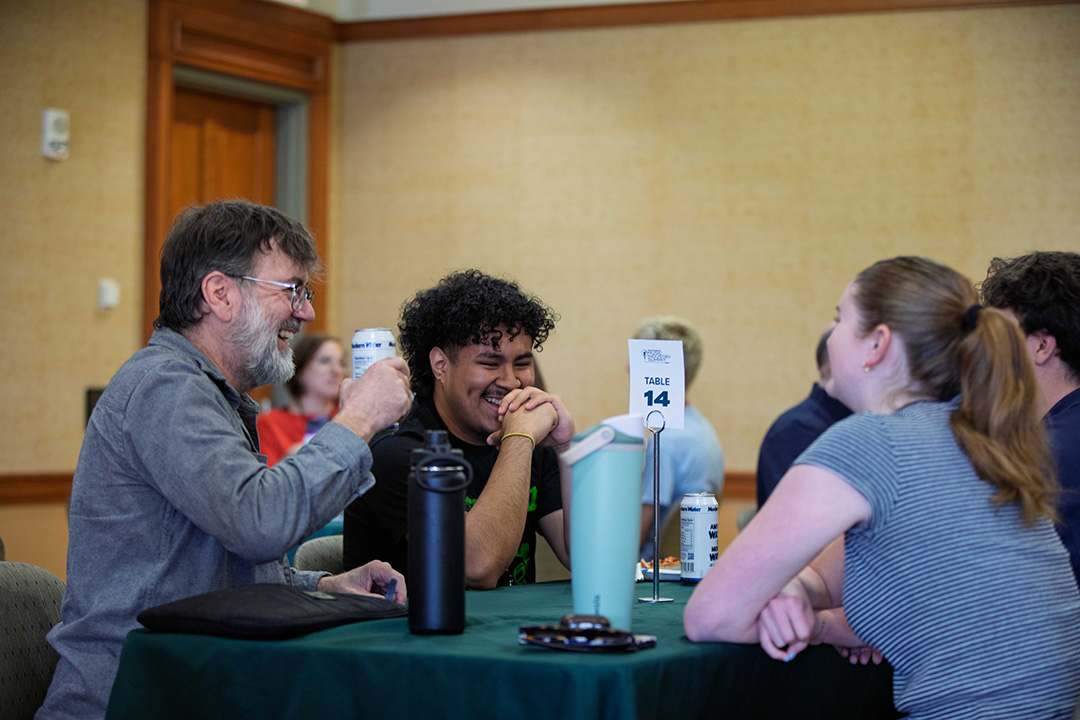 Mentors and attendees share a laugh during mentoring roundtable sessions.