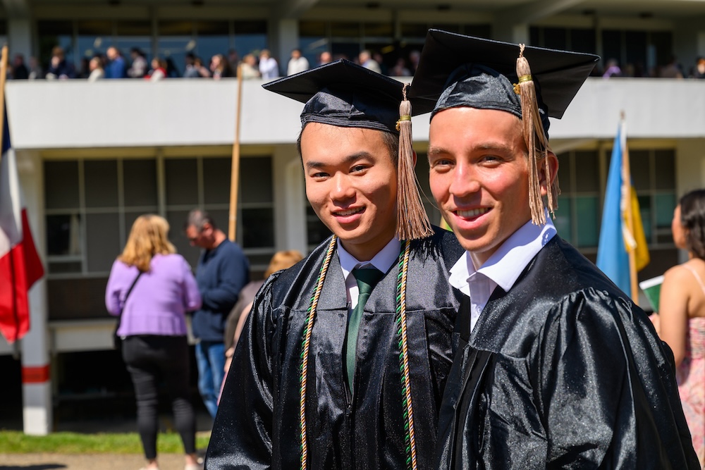 two new graduates smile for the camera