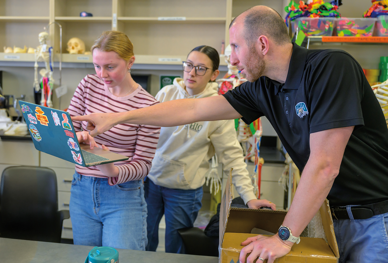 Ian Klein works with students