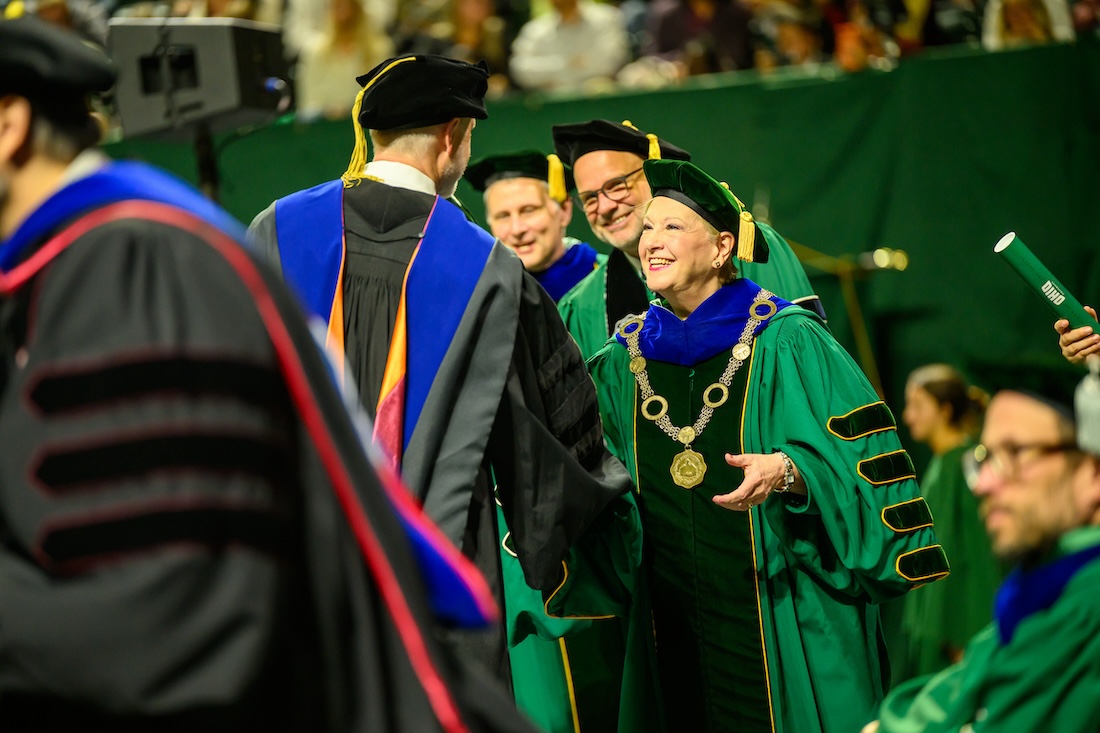 President Lori Stewart Gonzalez shakes the hand of a new graduate at the 2026 Spring Commencement ceremony